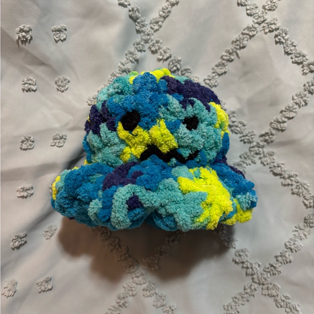 Reversible- multicolored- mad, blue-happy, hand crocheted plush octopus.